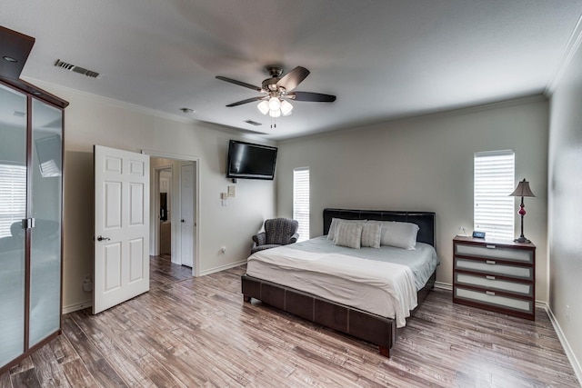 566 Glenn Ln, Red Oak, TX 75154 - bedroom with crown molding, wood finished floors, multiple windows, and baseboards