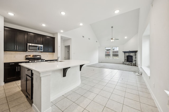 3903 Rochelle Ln, Forney, TX 75126 - kitchen featuring stainless steel appliances, a sink, ceiling fan, light tile patterned flooring, and vaulted ceiling