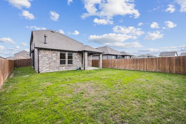 3903 Rochelle Ln, Forney, TX 75126 - rear view of house featuring brick siding, a patio area, and roof with shingles