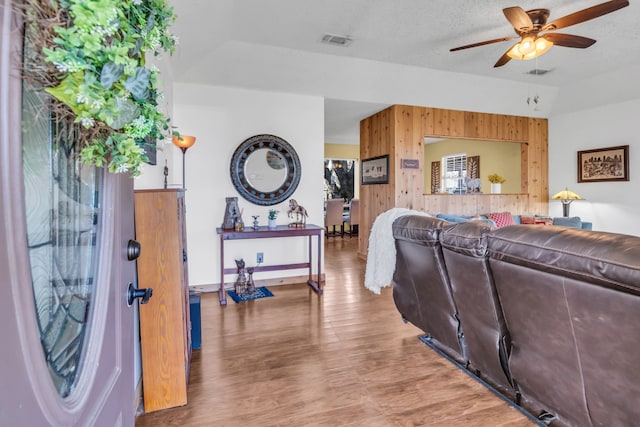 836 Silver Creek Rd, Azle, TX 76020 - living room featuring wood walls, ceiling fan, wood finished floors, and baseboards