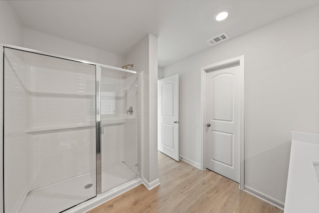 4701 Fillmore Dr, Greenville, TX 75401 - full bath with wood finished floors, a shower stall, and baseboards