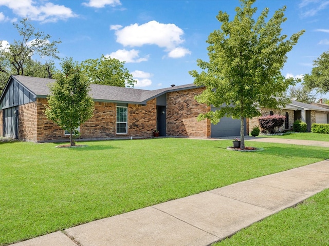 5601 Briarcrest Dr, Garland, TX 75043 - view of front of property with an attached garage, concrete driveway, a front lawn, and brick siding