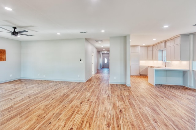 808 N Main St, Tioga, TX 76233 - unfurnished living room with a sink, light wood finished floors, recessed lighting, ceiling fan, and baseboards