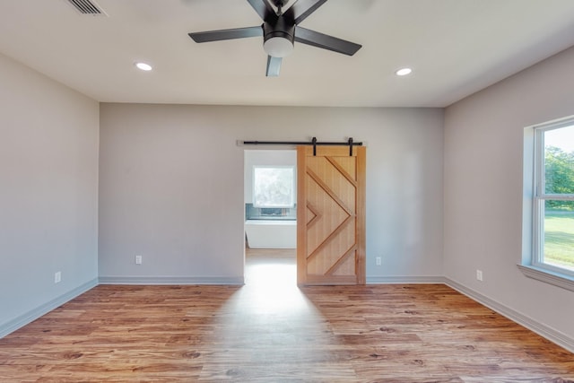 808 N Main St, Tioga, TX 76233 - unfurnished room with a barn door, light wood finished floors, recessed lighting, baseboards, and ceiling fan
