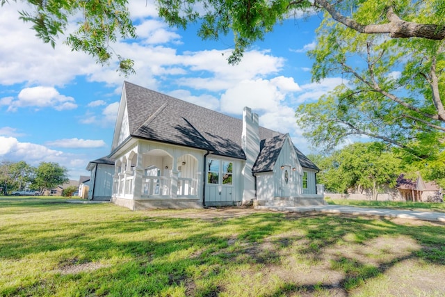 808 N Main St, Tioga, TX 76233 - view of front facade featuring a front lawn, a chimney, board and batten siding, and a shingled roof