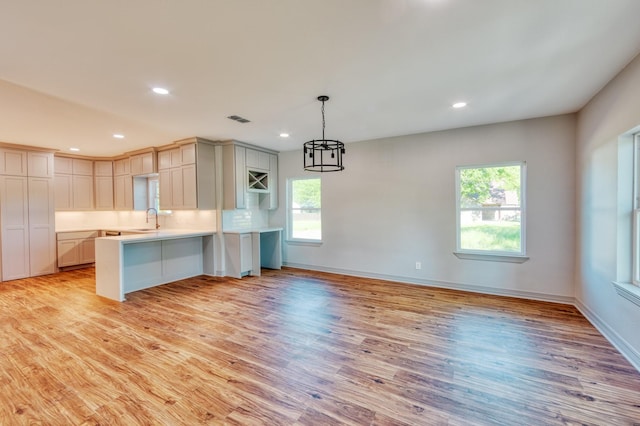 808 N Main St, Tioga, TX 76233 - kitchen with a sink, a peninsula, healthy amount of natural light, light wood-type flooring, and recessed lighting