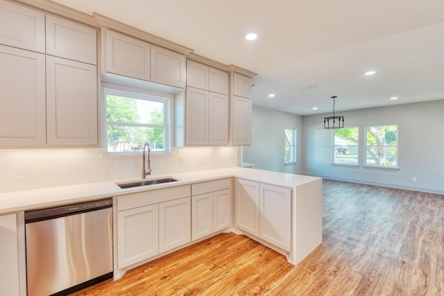 808 N Main St, Tioga, TX 76233 - kitchen featuring stainless steel dishwasher, a sink, light wood-style floors, light countertops, and a peninsula