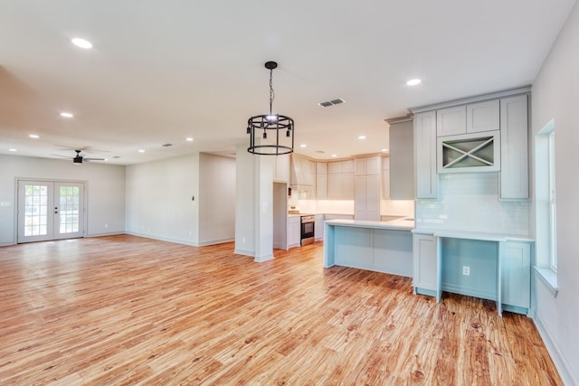 808 N Main St, Tioga, TX 76233 - kitchen with gray cabinets, light countertops, light wood finished floors, tasteful backsplash, and recessed lighting