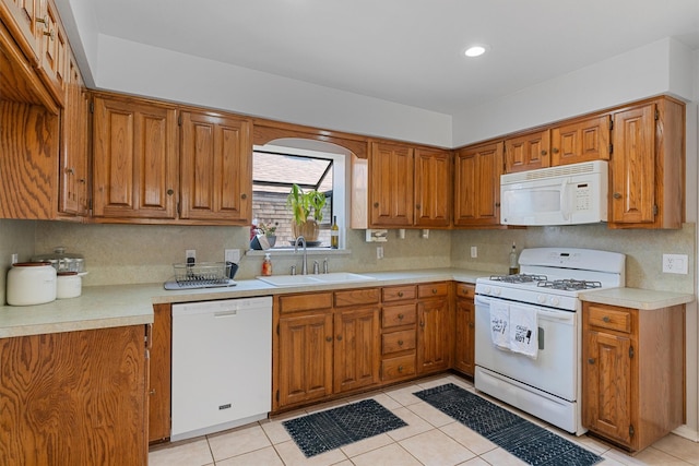 3410 Country Club Pl, Grand Prairie, TX 75052 - kitchen featuring white appliances, a sink, brown cabinets, light countertops, and recessed lighting