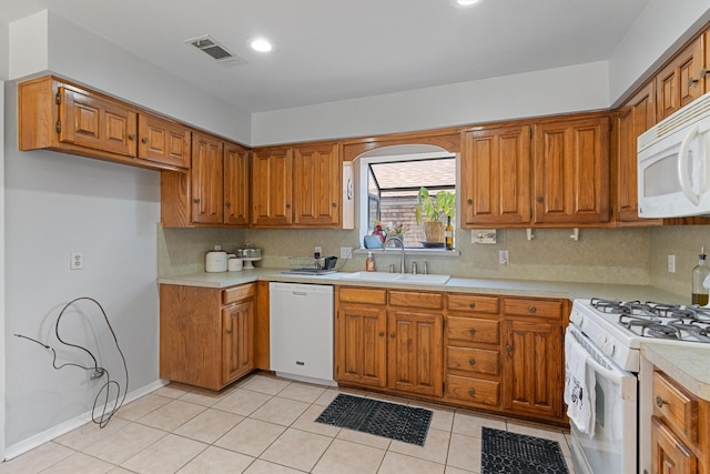 3410 Country Club Pl, Grand Prairie, TX 75052 - kitchen with white appliances, a sink, brown cabinetry, light countertops, and backsplash