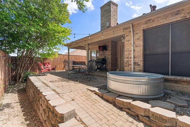 3410 Country Club Pl, Grand Prairie, TX 75052 - view of patio with a fenced backyard, a hot tub, outdoor dining area, and area for grilling