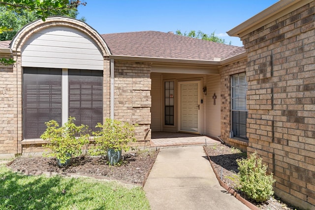 3410 Country Club Pl, Grand Prairie, TX 75052 - view of exterior entry featuring brick siding and roof with shingles