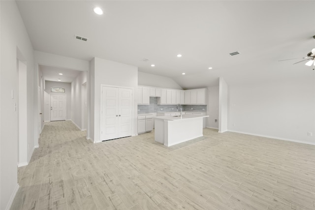 9332 Bali Dr, Fort Worth, TX 76123 - kitchen with open floor plan, light countertops, tasteful backsplash, light wood-style flooring, and vaulted ceiling