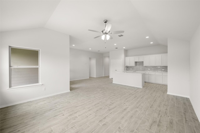 9332 Bali Dr, Fort Worth, TX 76123 - unfurnished living room featuring lofted ceiling, ceiling fan, light wood finished floors, a sink, and recessed lighting