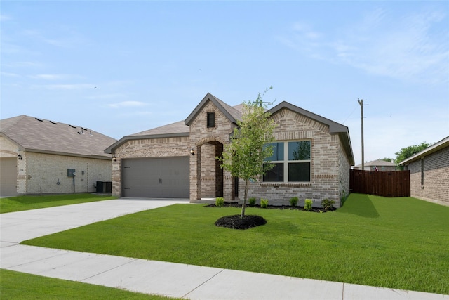 9332 Bali Dr, Fort Worth, TX 76123 - french country home featuring brick siding, a garage, driveway, and central AC