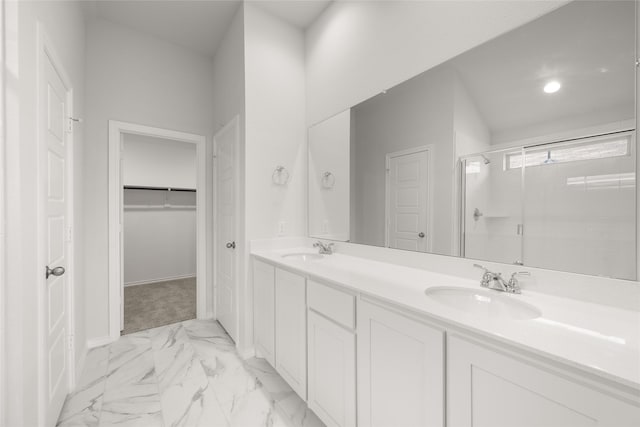 9332 Bali Dr, Fort Worth, TX 76123 - bathroom featuring a stall shower, marble finish floors, double vanity, a walk in closet, and baseboards