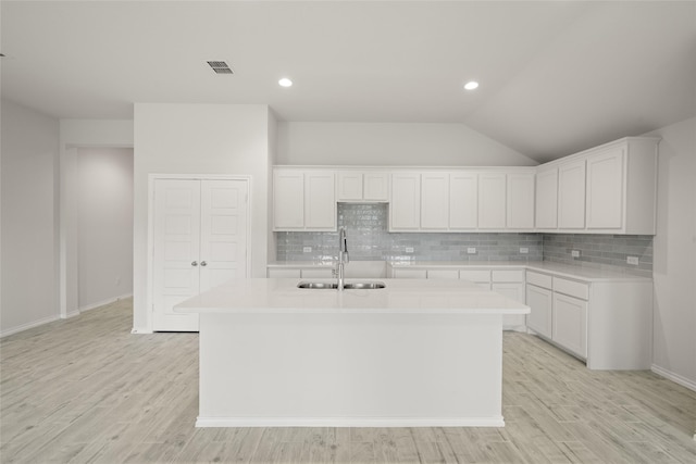 9332 Bali Dr, Fort Worth, TX 76123 - kitchen with a sink, a kitchen island with sink, decorative backsplash, light countertops, and lofted ceiling