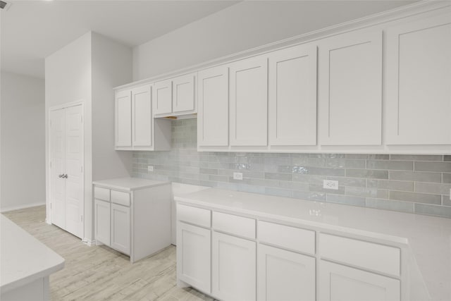 9332 Bali Dr, Fort Worth, TX 76123 - kitchen with tasteful backsplash, light wood-style floors, light countertops, white cabinets, and baseboards