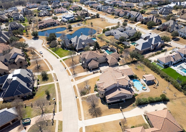 aerial view of property's location featuring nearby suburban area and a large body of water