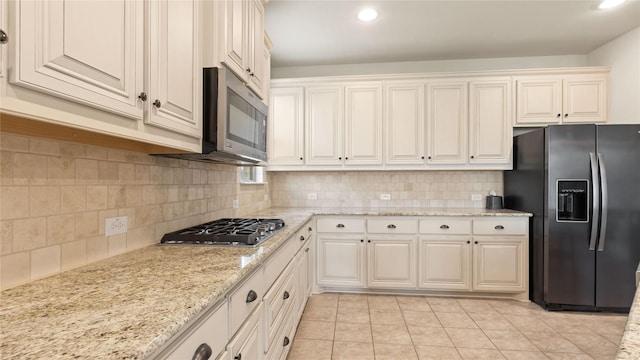 5100 Ambergate Ln, Sherman, TX 75092 - kitchen featuring appliances with stainless steel finishes, light tile patterned flooring, recessed lighting, decorative backsplash, and light stone countertops