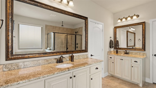 5100 Ambergate Ln, Sherman, TX 75092 - bathroom featuring a stall shower, two vanities, tile patterned floors, and baseboards