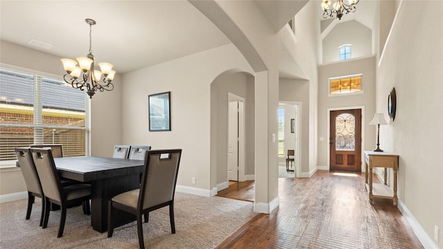 5100 Ambergate Ln, Sherman, TX 75092 - dining room with a chandelier, arched walkways, wood finished floors, and baseboards