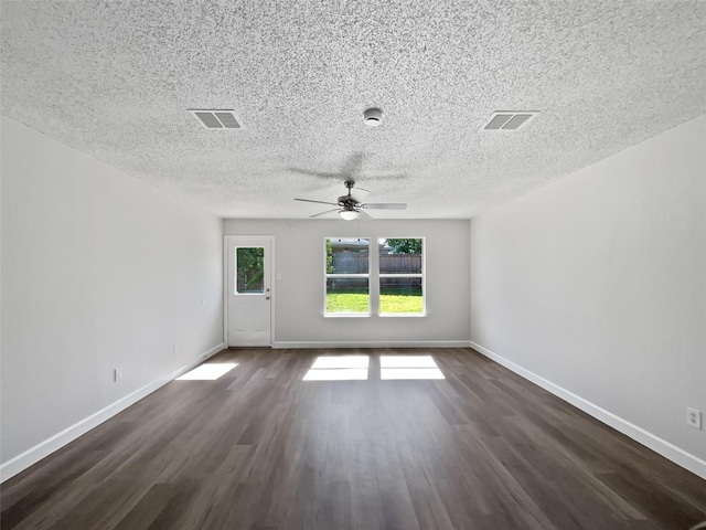 110 Nighthawk Dr, Krum, TX 76249 - spare room featuring dark wood-style flooring, a ceiling fan, baseboards, and a textured ceiling