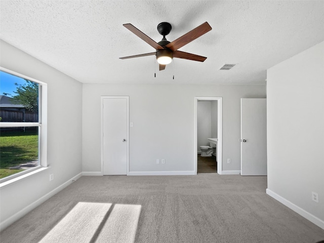 110 Nighthawk Dr, Krum, TX 76249 - unfurnished bedroom with carpet floors, a textured ceiling, baseboards, ensuite bath, and a ceiling fan