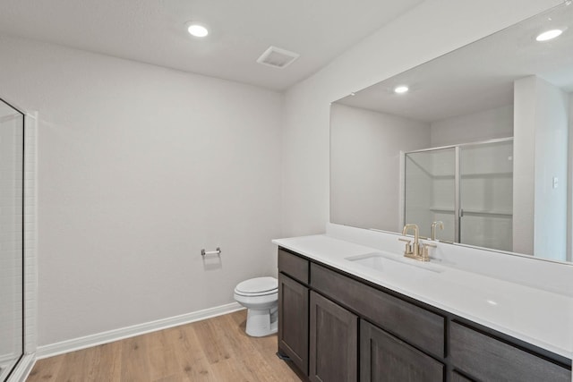 4702 Fillmore Dr, Greenville, TX 75401 - bathroom featuring a shower stall, wood finished floors, toilet, baseboards, and recessed lighting