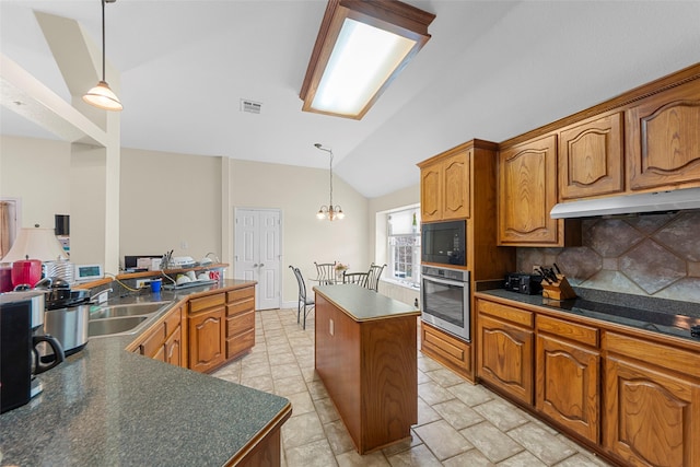 1409 Kingsley Dr, Allen, TX 75013 - kitchen with black appliances, a sink, under cabinet range hood, dark countertops, and lofted ceiling