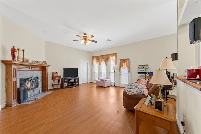 1409 Kingsley Dr, Allen, TX 75013 - living area featuring a ceiling fan, wood finished floors, a tile fireplace, and baseboards
