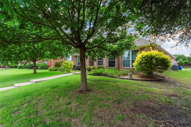 1409 Kingsley Dr, Allen, TX 75013 - obstructed view of property with a front yard, brick siding, and cooling unit