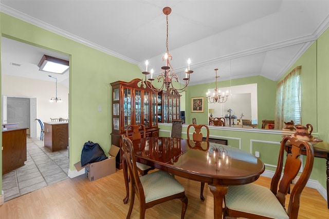 1409 Kingsley Dr, Allen, TX 75013 - dining area featuring a chandelier, light wood-style flooring, lofted ceiling, and ornamental molding