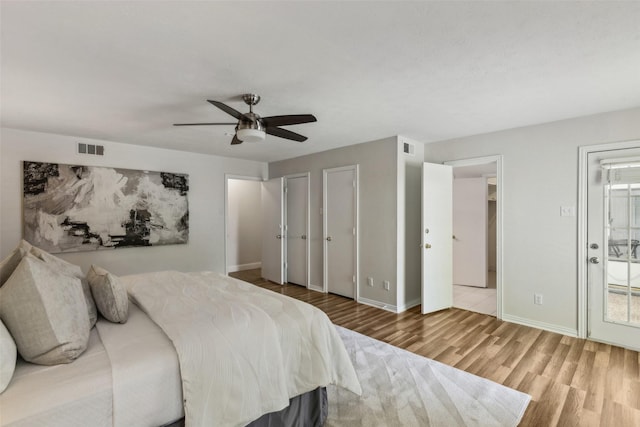 6908 Heatherknoll Dr, Dallas, TX 75248 - bedroom featuring wood finished floors, baseboards, a ceiling fan, and multiple closets