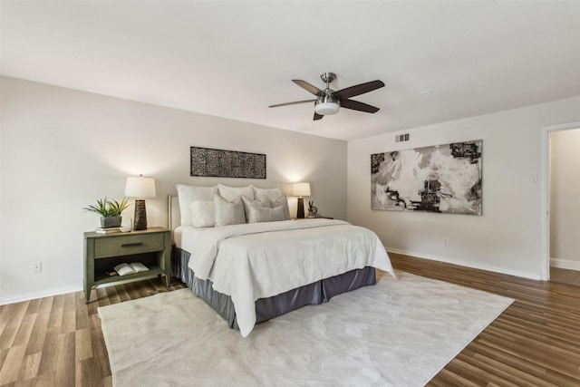 6908 Heatherknoll Dr, Dallas, TX 75248 - bedroom with wood finished floors, baseboards, and a ceiling fan