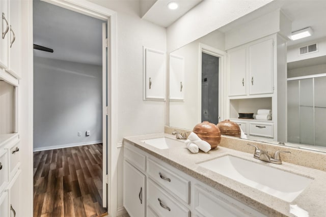 6908 Heatherknoll Dr, Dallas, TX 75248 - bathroom featuring wood finished floors, double vanity, and an enclosed shower