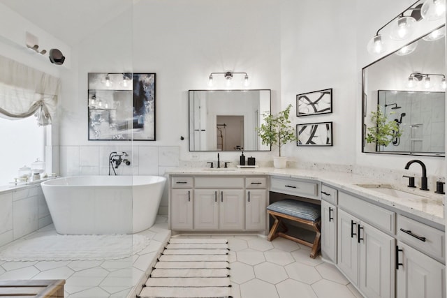 2512 Green Meadow Dr, Sachse, TX 75048 - bathroom with a freestanding tub, two vanities, a shower, tile patterned floors, and high vaulted ceiling