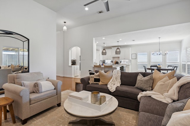 2512 Green Meadow Dr, Sachse, TX 75048 - living area with ceiling fan, arched walkways, a chandelier, plenty of natural light, and recessed lighting