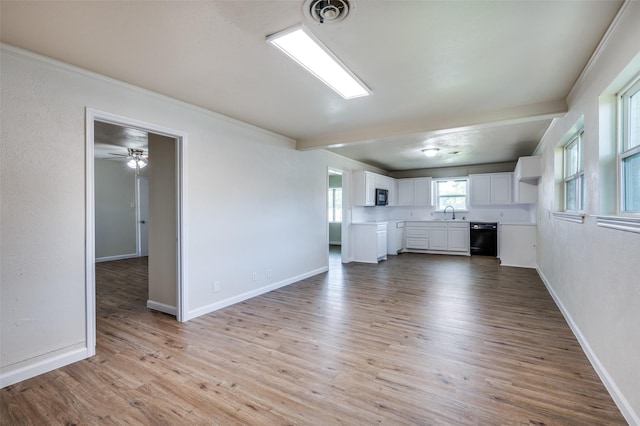 5217 Mack Rd, Haltom City, TX 76117 - unfurnished living room featuring wood finished floors, baseboards, a sink, and ceiling fan