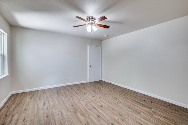 5217 Mack Rd, Haltom City, TX 76117 - spare room with a ceiling fan, light wood finished floors, and baseboards