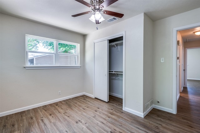 5217 Mack Rd, Haltom City, TX 76117 - unfurnished bedroom with wood finished floors, baseboards, a closet, and ceiling fan