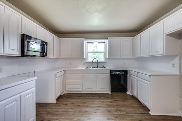 5217 Mack Rd, Haltom City, TX 76117 - kitchen with dishwasher, a sink, wood finished floors, and white cabinets