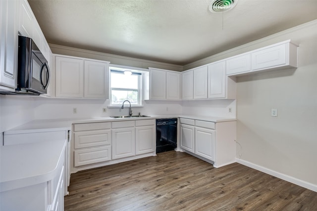 5217 Mack Rd, Haltom City, TX 76117 - kitchen with a sink, black appliances, wood finished floors, white cabinetry, and baseboards