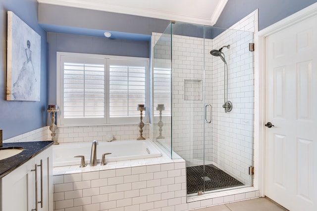 bathroom featuring crown molding, a bath, a stall shower, and vanity