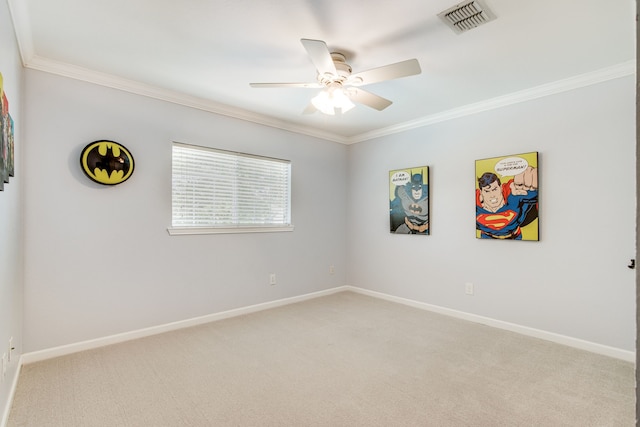 empty room featuring ornamental molding, light carpet, a ceiling fan, and baseboards