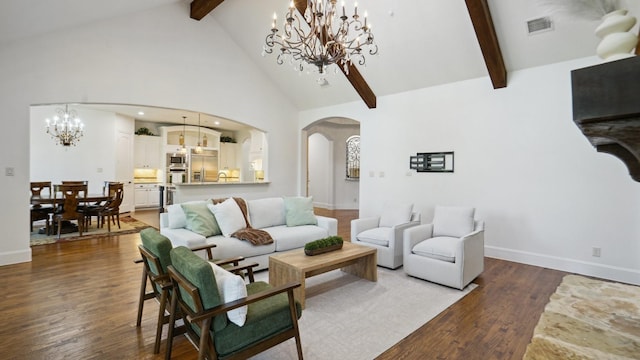living area featuring arched walkways, beamed ceiling, a chandelier, high vaulted ceiling, and wood finished floors