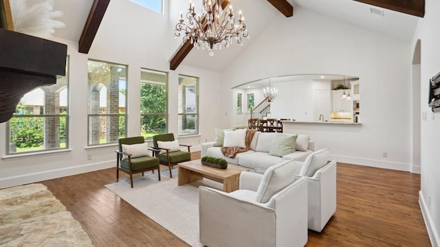 living room with a chandelier, arched walkways, beam ceiling, high vaulted ceiling, and wood finished floors