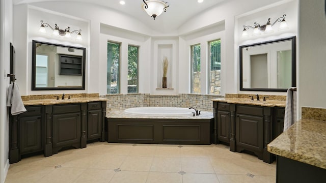 full bath with lofted ceiling, a garden tub, two vanities, and tile patterned flooring