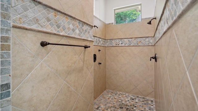 bathroom with a tile shower