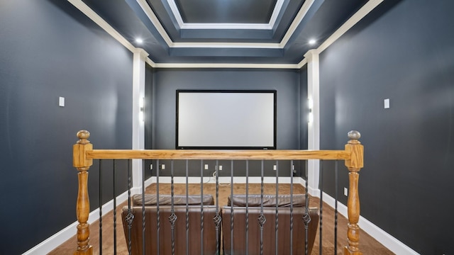 home theater featuring crown molding, baseboards, and a raised ceiling